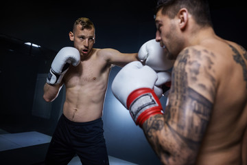 Fototapeta na wymiar Professional boxer training with left hits