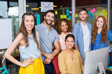 Smiling graphic designers working at desk in office