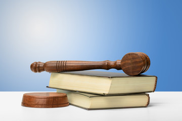 Wooden gavel and books on wooden table