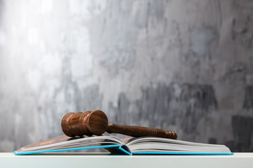 Wooden gavel and books on wooden table