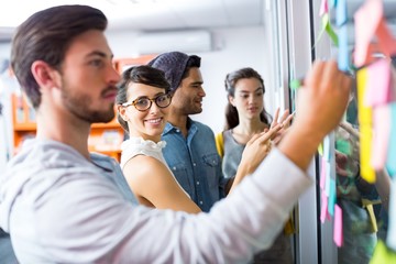 Executives writing on sticky notes