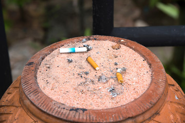 cigarette stubs, cigarette butts on sand
