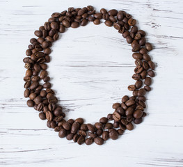 .O  letter of the English alphabet made of coffee beans. Light, old wooden background. Selective focus..