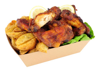 Chicken wings and potato wedges in a cardboard take away tray isolated on a white background