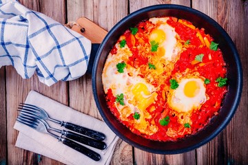 Shakshuka. Fried eggs with tomato, paprika and parsley