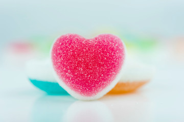 Fototapeta premium Heart candies coated with sugar, heart colorful sweet candies, sugar heart shaped candy