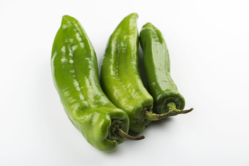 Close-up of three green peppers on white background. Isolated.