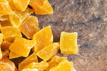 Dried and candied mango on rustic background. Top view with copy space