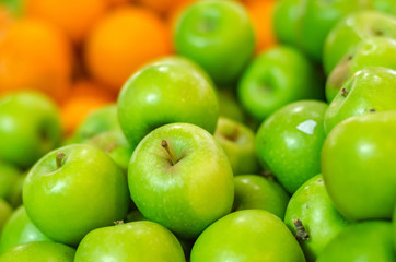 green apple background display at market stall. selective focus shot