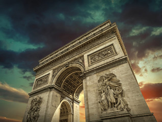 Fototapeta na wymiar Arc de Triomphe in Paris under sky with clouds. One of symbols o