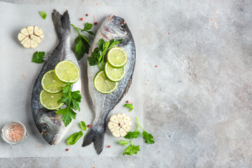 two raw dorado fish with lime and parsley ready to cooking