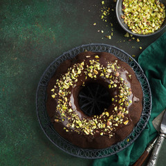 chocolate bundt cake with chocolate glaze and pistachios