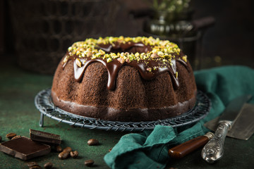 chocolate bundt cake with chocolate glaze and pistachios