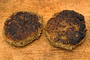 Cutlets on rustic wooden background from above