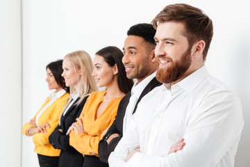 Happy colleagues standing in office posing.