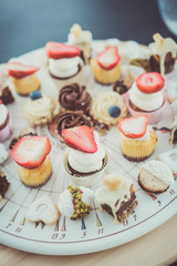 Dessert bar with delicious cake pops and different sweets on a plate