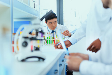 young doctors in uniform working at testing laboratory, chemical laboratory