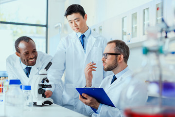 Fototapeta premium young doctors in uniform working at testing laboratory, laboratory technicians