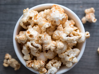 popcorn in a bowl on a wooden background