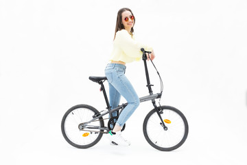 Obraz premium Smiling young girl on collapsible bike