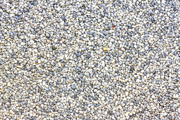Background of smooth pebbles in different colors and sizes on the beach