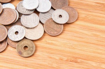 Japanese coins on wooden table.