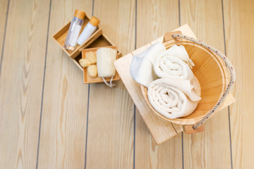 Towel in a pine tank on the wooden floor in bathroom