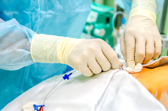 An anesthesiologist establishes a central catheter to the patient before surgery.