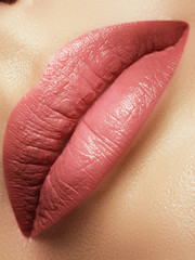 Close-up beautiful female lips with bright lipgloss makeup. Perfect clean skin, light fresh lip make-up
