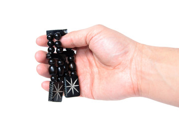Rosary in hand on a white background isolated