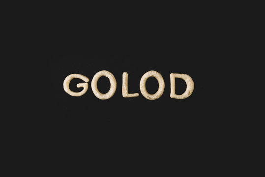 top view of word golod made from cookie dough isolated on black