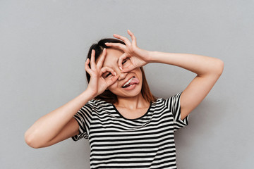 Young woman playing and showing tongue