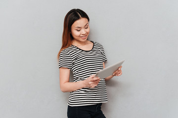 Beautiful young woman using tablet computer.