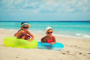 Fototapeta na wymiar cute little boy and toddler girl play on beach