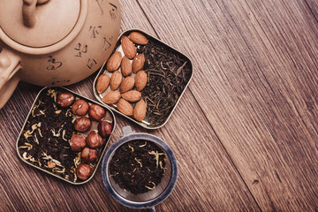 Tea strainer with tea on a wooden surface. Green and black tea Top view with copy space