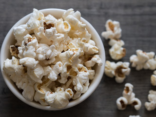 popcorn in a bowl on a wooden background