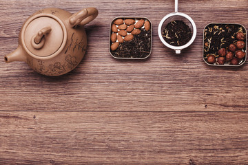 Tea strainer with tea on a wooden surface. Green and black tea Top view with copy space