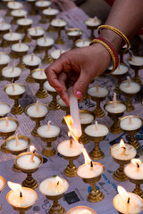 Nepali people lighting oil lamps on day of Vesak, Visaka, people praying for world peace and those who died on massive earthquake on 25 april 2015 in Nepal