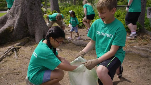 Group of volunteers cleaning up park