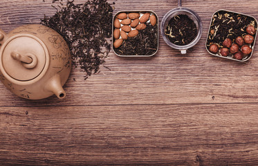 Tea strainer with tea on a wooden surface. Green and black tea Top view with copy space
