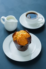 Muffin and coffee with milk.
