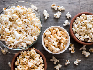 Poporn in bowls on wooden background