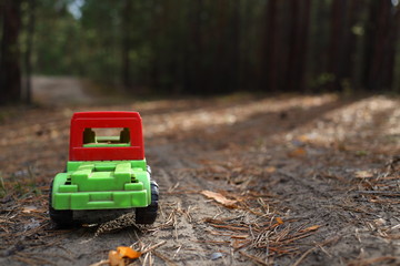 Fototapeta na wymiar Toy car on a forest road