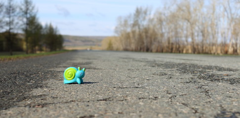Toy snail on the road
