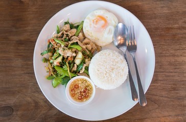 Thai food top view - Rice topped with stir-fried pork and basil with  Sunny Side Up 