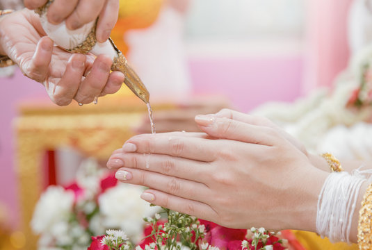 Picture of Hands Pouring Blessing Water into Bride's Hands, Thai wedding