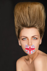 Portrait of woman with english flag on her face