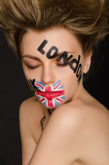 Inscriptions and flag of england on young woman's face