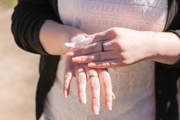 girl is wiping her hands with a napkin in the street
