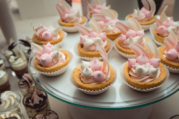 glass stand with cupcakes on a wedding candy bar table